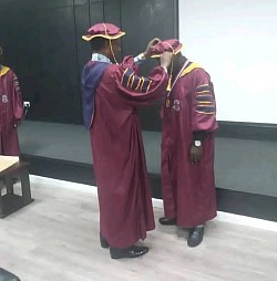 Dressing a Doctoral Graduating Student
