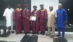 A group photograph with the father and few friends of the doctoral graduating student.